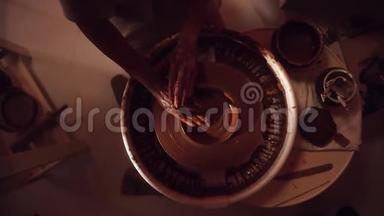 陶工`用托盘和手成型小泥板的车轮的俯视图